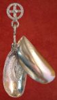 X6-A pendant in the form of a bi-valve mussel shell in which is depicted a vulva